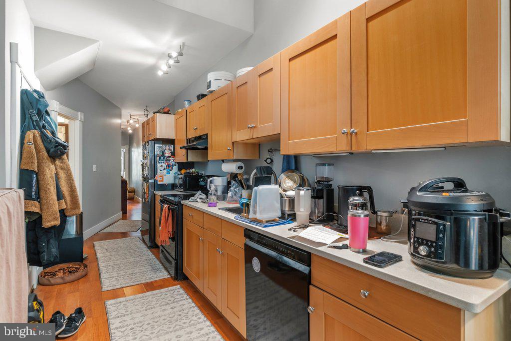 1215 John Street Baltimore, MD 21217 - Photo 23 of 34 a kitchen with stainless steel appliances granite countertop a sink a stove and a refrigerator