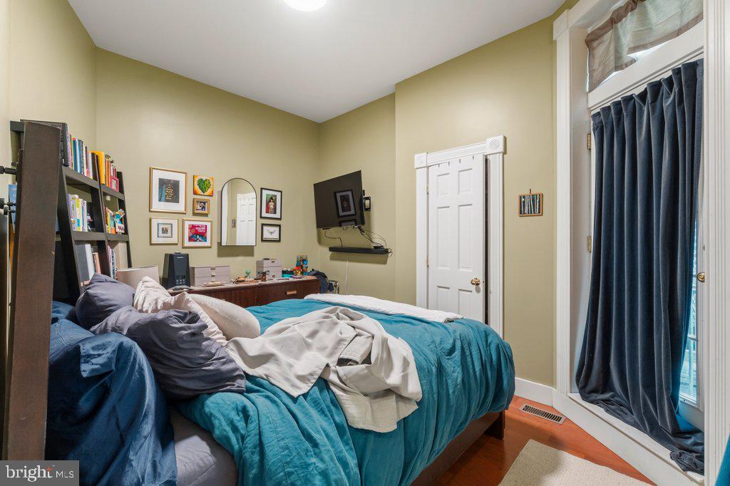 1215 John Street Baltimore, MD 21217 - Photo 24 of 34 a bedroom with two beds and a large mirror