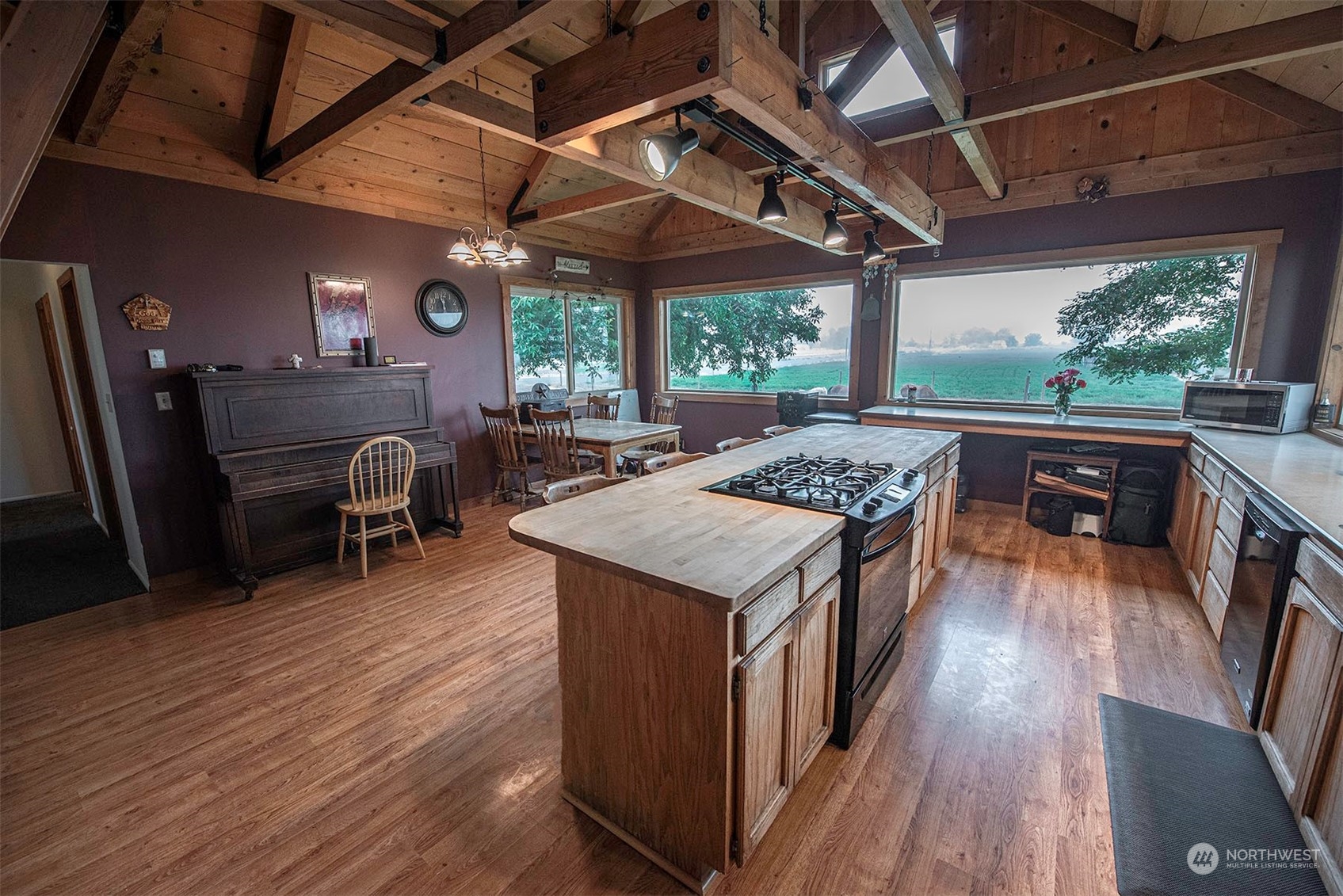 1666 Cummins Road Touchet, WA 99360 - Photo 6 of 35 a open kitchen with stainless steel appliances granite countertop a stove a refrigerator a dining table and chairs with wooden floor