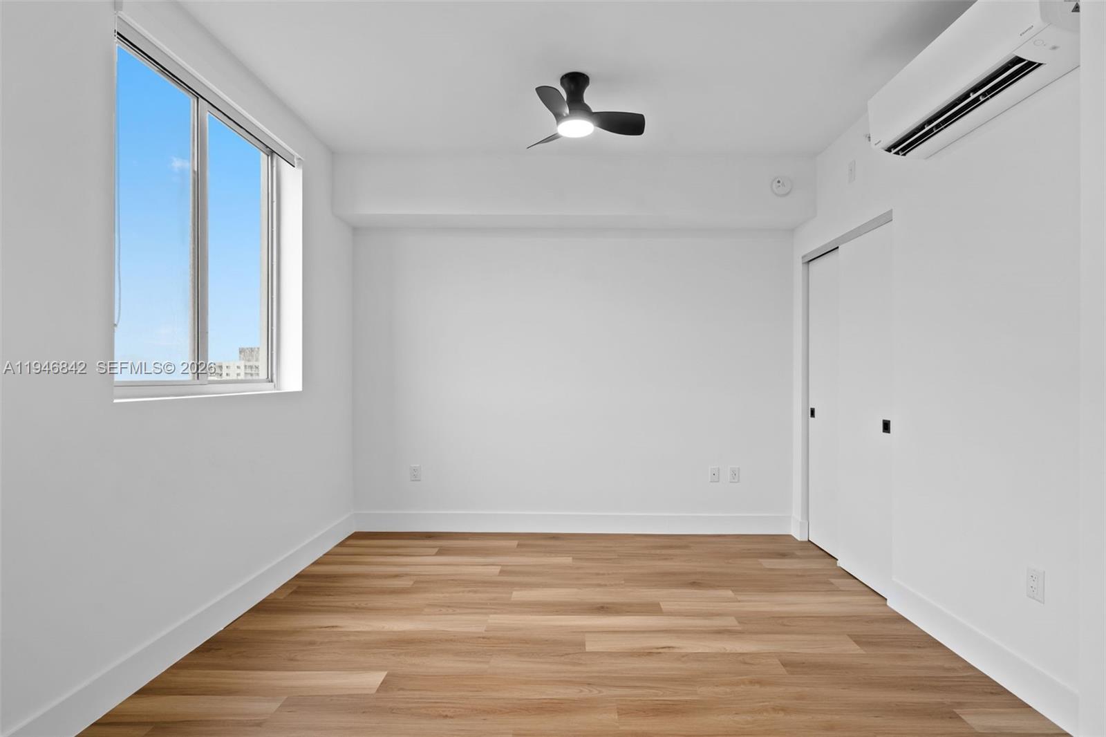 650 Southwest 1st Street, Unit 402 Miami, FL 33130 - Photo 6 of 11 a view of empty room with wooden floor and fan