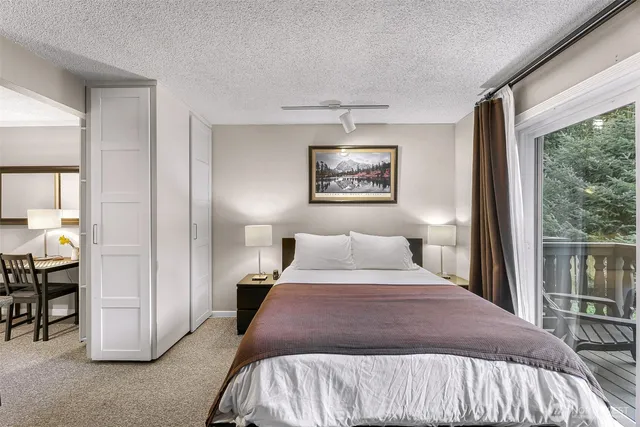 a bedroom with a bed and a painting on the wall