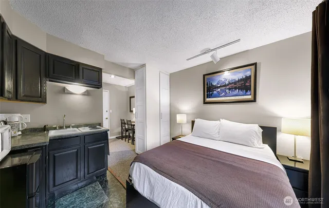 a bedroom with a bed and a desk