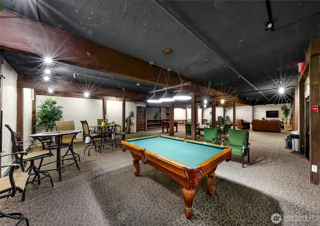 a area with pool table and chairs