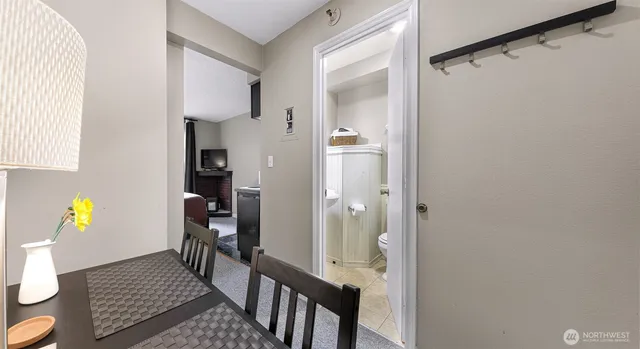 a view of entryway with wooden floor and bathroom