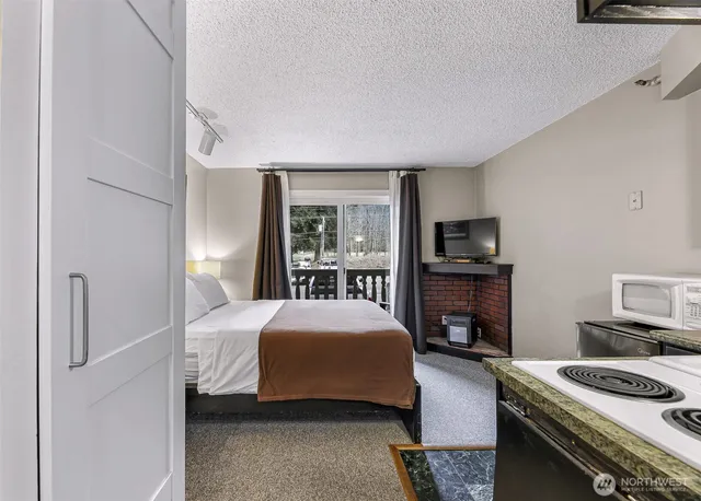 a bedroom with a bed and a flat screen tv