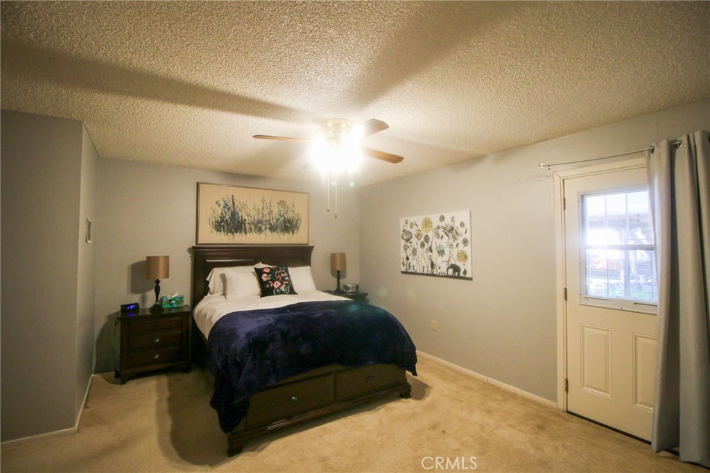 25669 Warwick Road Menifee, CA 92586 - Photo 11 of 36 a bedroom with a bed and window