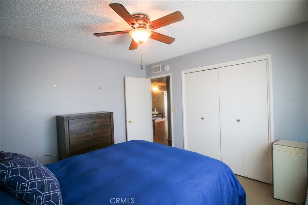 25669 Warwick Road Menifee, CA 92586 - Photo 14 of 36 a bedroom with a bed and a closet