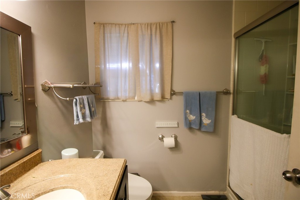 25669 Warwick Road Menifee, CA 92586 - Photo 15 of 36 a bathroom with a sink toilet and shower