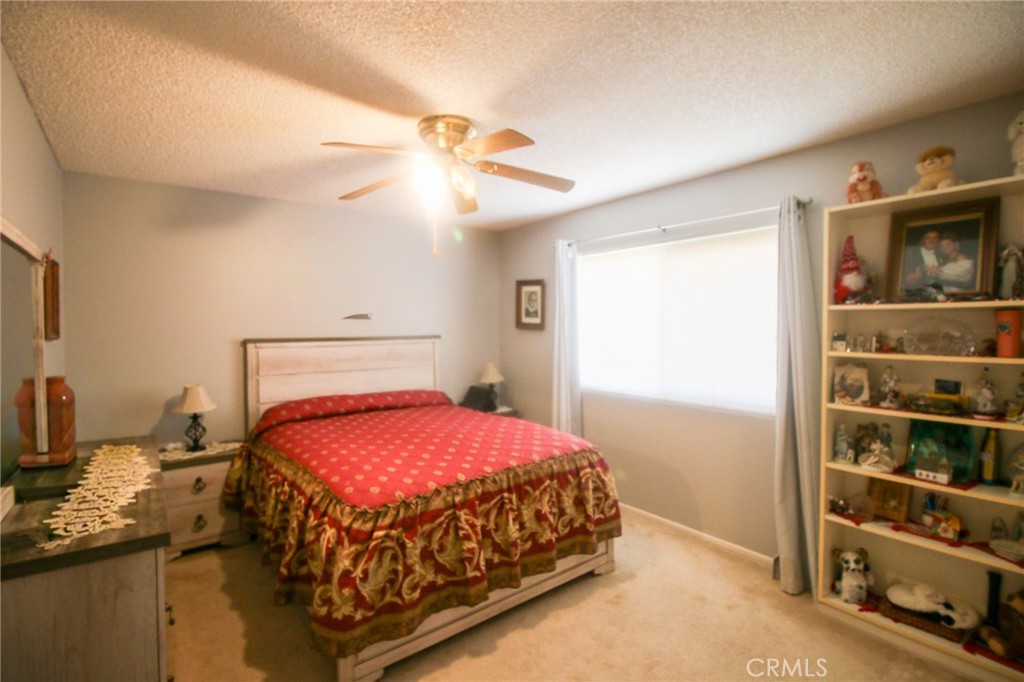 25669 Warwick Road Menifee, CA 92586 - Photo 16 of 36 a bedroom with a bed and a window