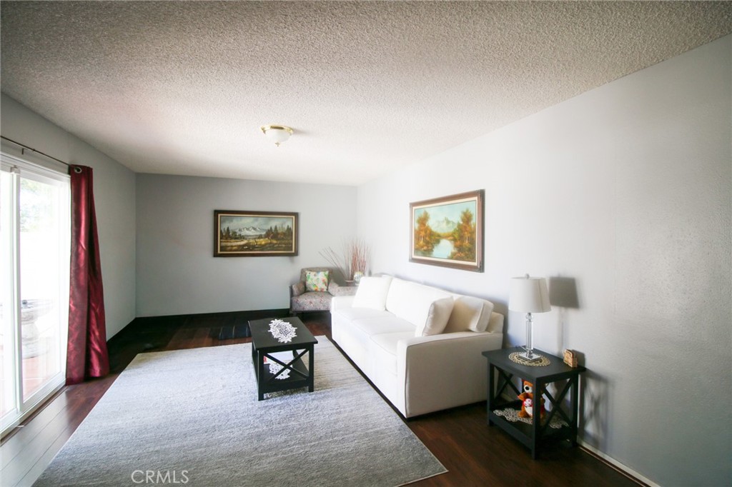 25669 Warwick Road Menifee, CA 92586 - Photo 4 of 36 a bedroom with a bed and a couch