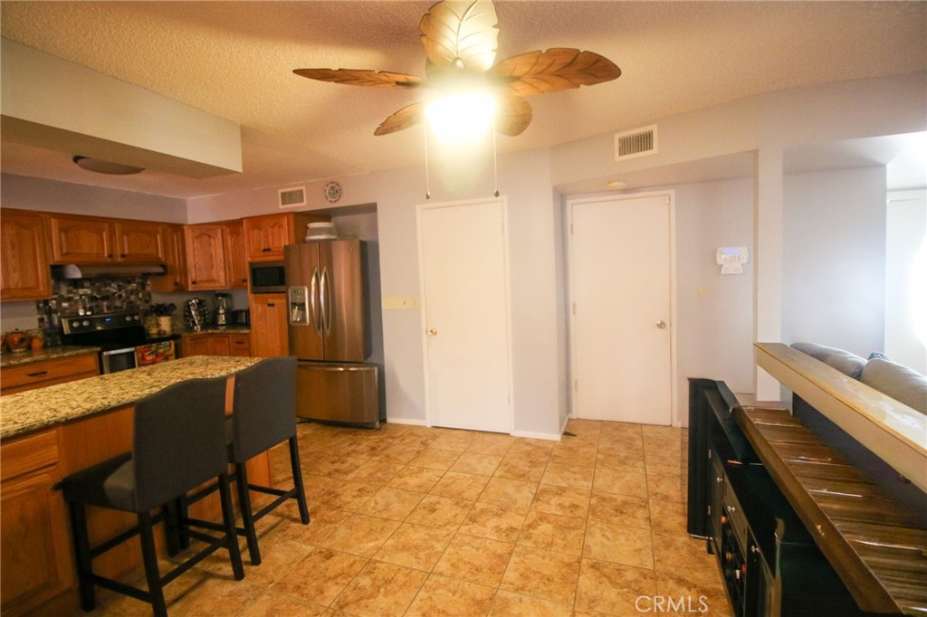 25669 Warwick Road Menifee, CA 92586 - Photo 6 of 36 a kitchen with a table and chairs in it