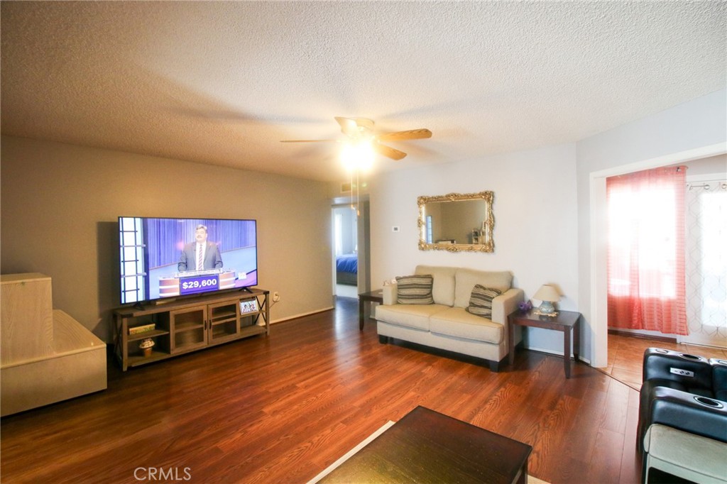 25669 Warwick Road Menifee, CA 92586 - Photo 8 of 36 a living room with furniture and a flat screen tv