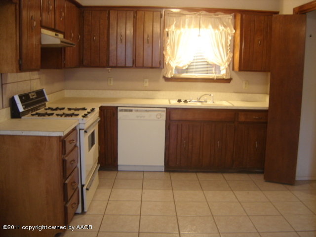 5321 Capulin Lane Amarillo, TX 79110 - Photo 4 of 14 a kitchen with a sink cabinets and a window
