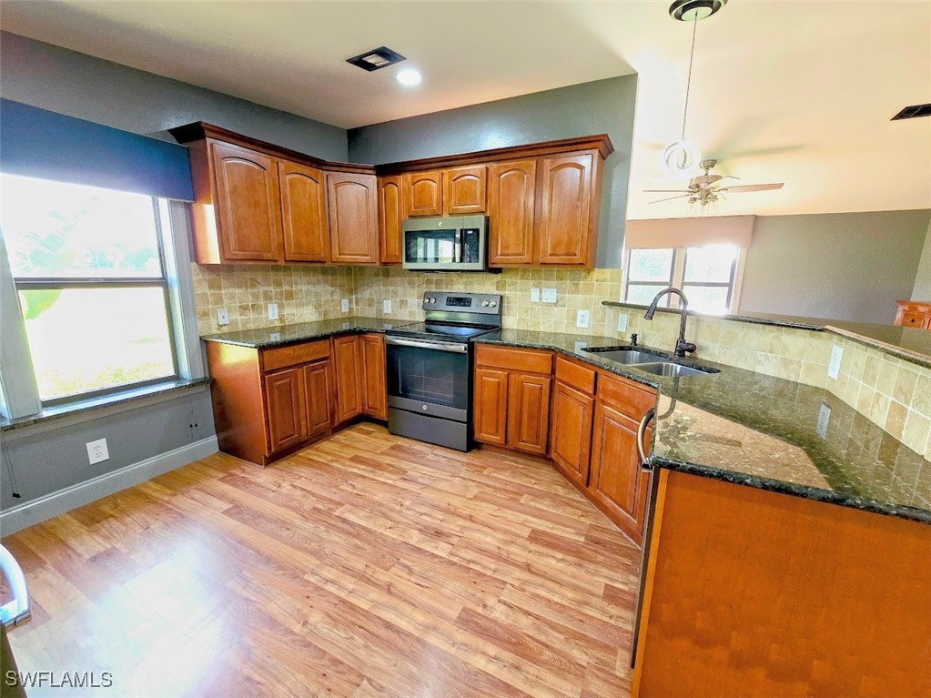 4650 County Road 78 LaBelle, FL 33935 - Photo 12 of 21 a kitchen with stainless steel appliances granite countertop sink stove and granite counter top