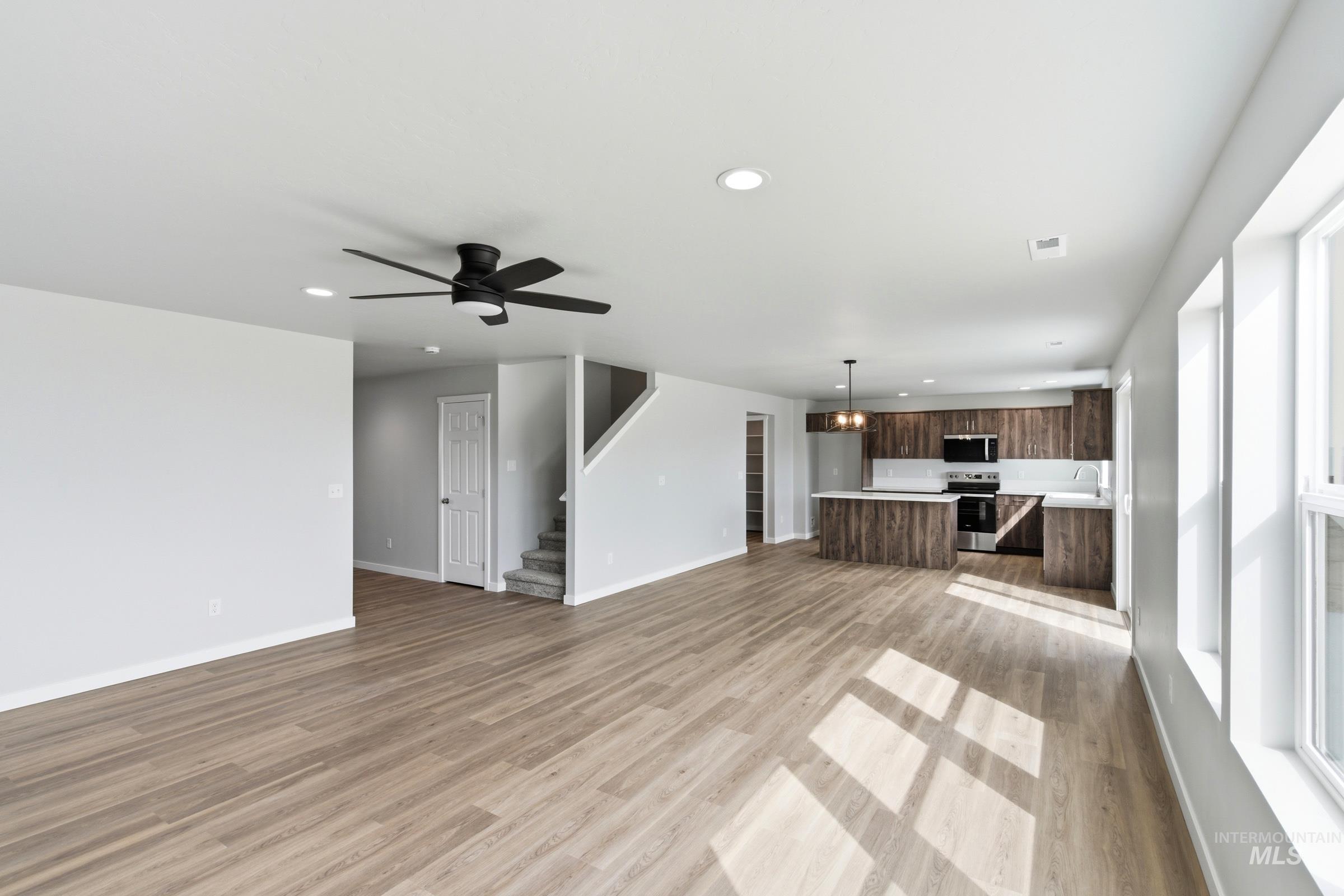 16558 Dunning Way Caldwell, ID 83607 - Photo 10 of 35 Open-concept living space featuring wood-finish flooring, recessed lighting, and a modern ceiling fan