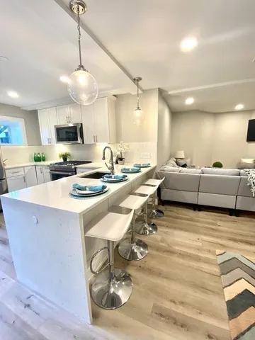 a large kitchen with a table and chairs