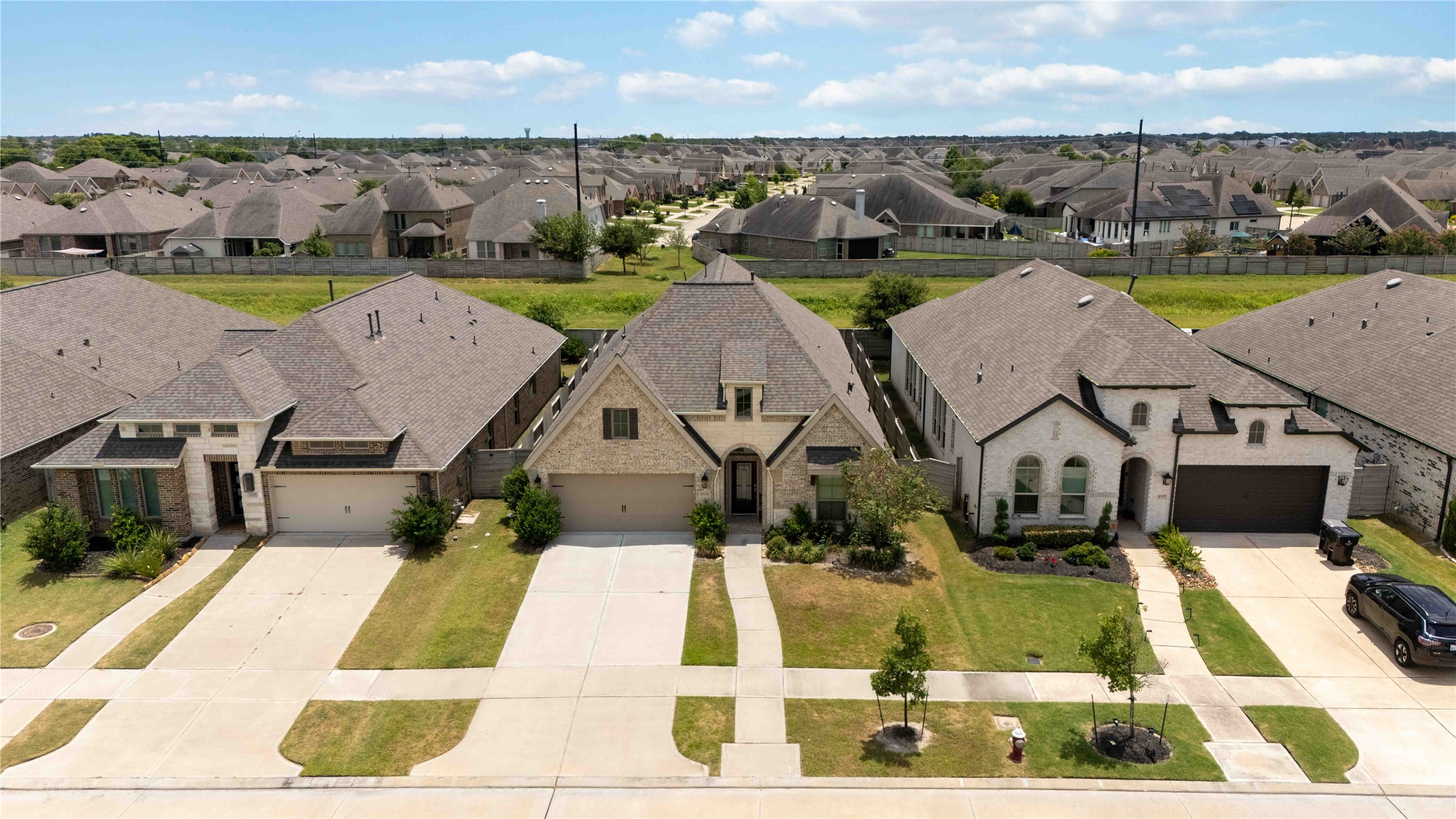 4333 Arbor Crest Lane Manvel, TX 77578 - Photo 29 of 40 An elevated look at the home’s striking front architecture, highlighting its curb appeal and its place within the clean, modern streetscape of Pomona.
