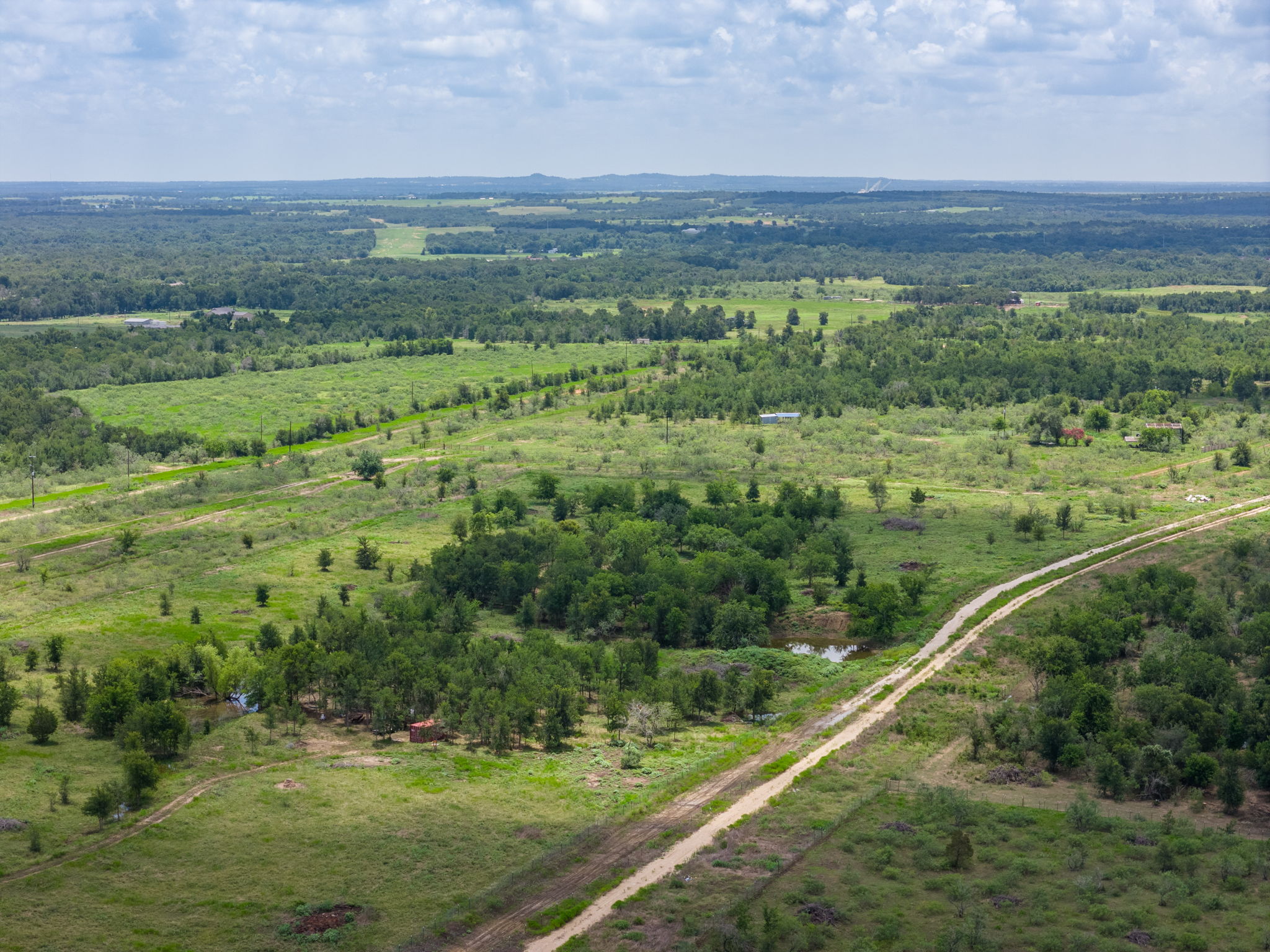 3280 County Road 466, Unit 2 Elgin, TX 78621 - Photo 4 of 4 a view of a city with lush green forest