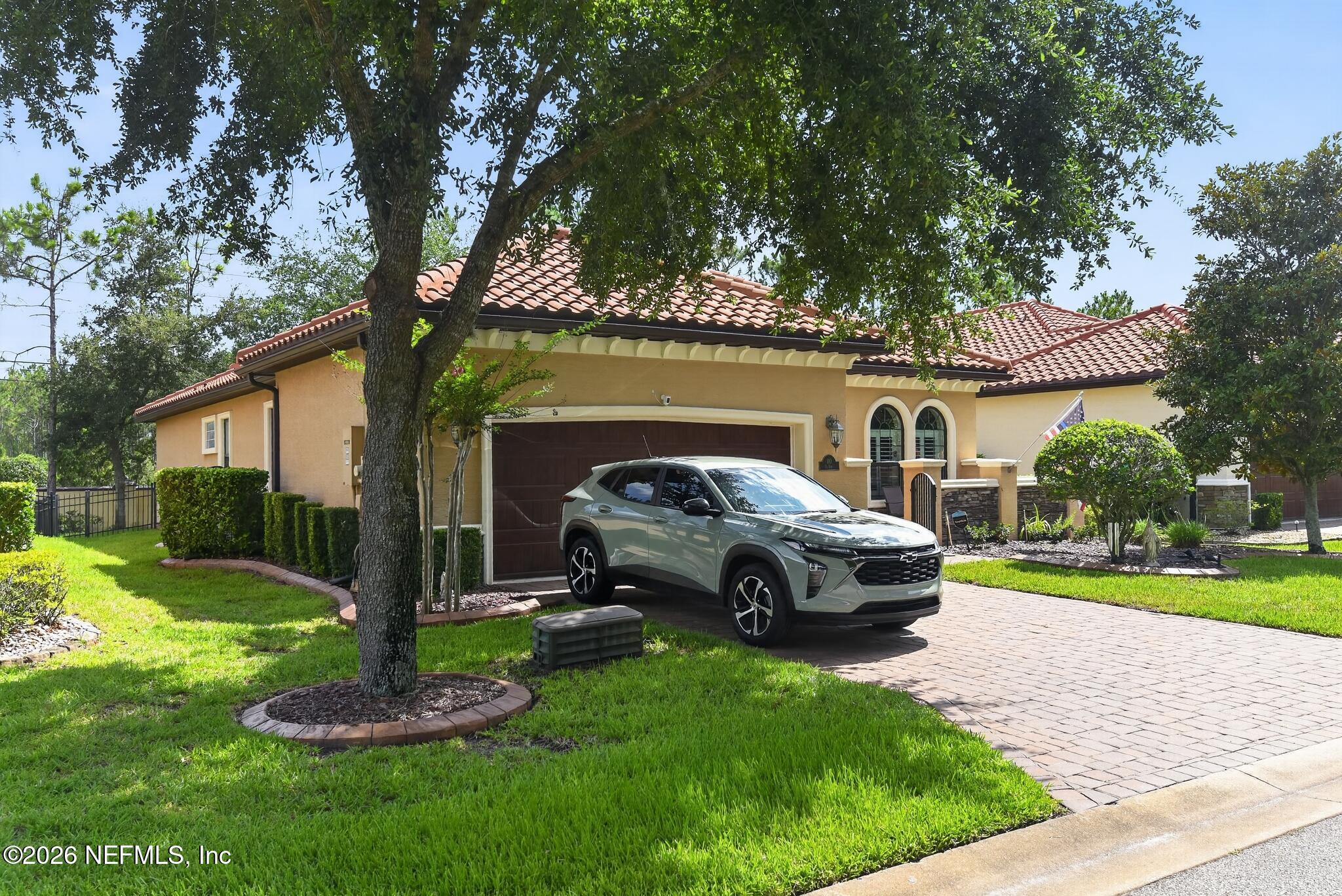 110 Vía Roma Ormond Beach, FL 32174 - Photo 4 of 43 a front view of a house with garden