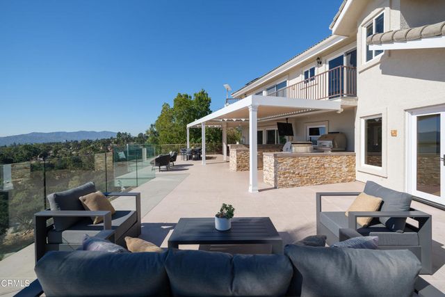 a bathroom with a tub a sink and a large mirror