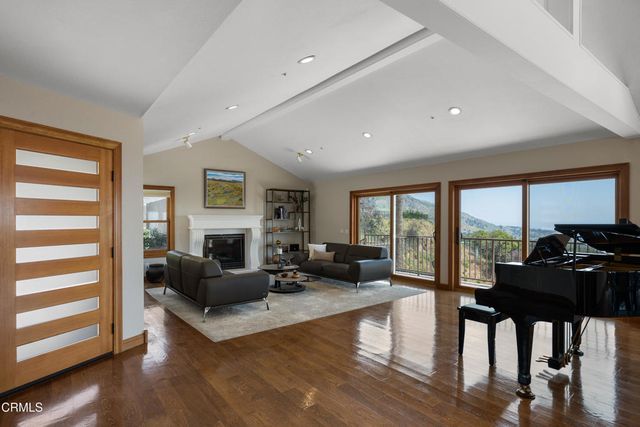 a dining room with furniture a rug and wooden floor