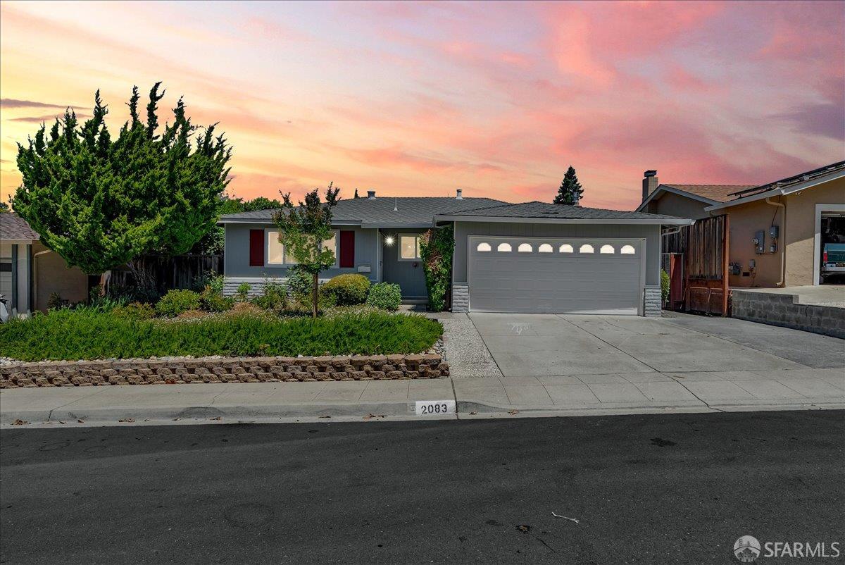 a front view of a house with a garden
