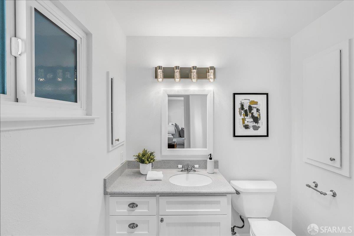 2083 Seacliff Drive Milpitas, CA 95035 - Photo 40 of 59 a bathroom with a toilet sink and mirror