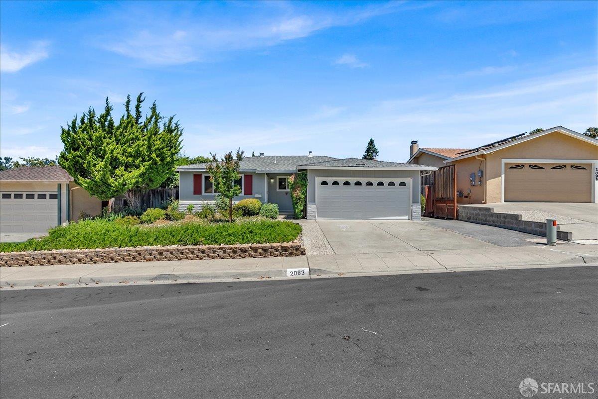 2083 Seacliff Drive Milpitas, CA 95035 - Photo 7 of 59 a front view of a house with a yard and garage