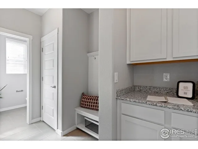a kitchen with granite countertop a sink cabinets and stainless steel appliances