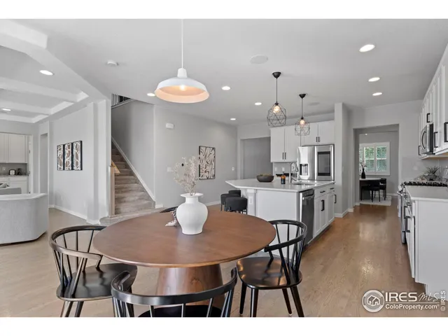 a kitchen with stainless steel appliances a dining table chairs and kitchen view
