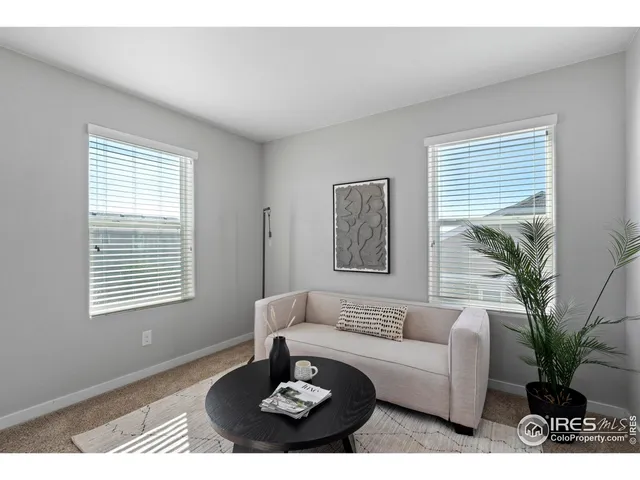 a living room with furniture potted plant and a window