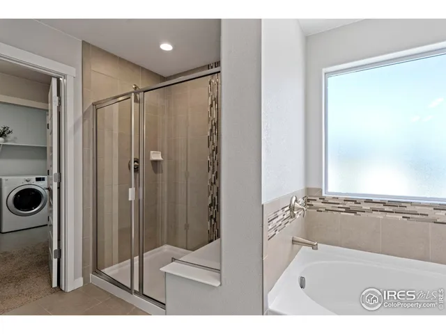 a bathroom with a tub a sink and a shower