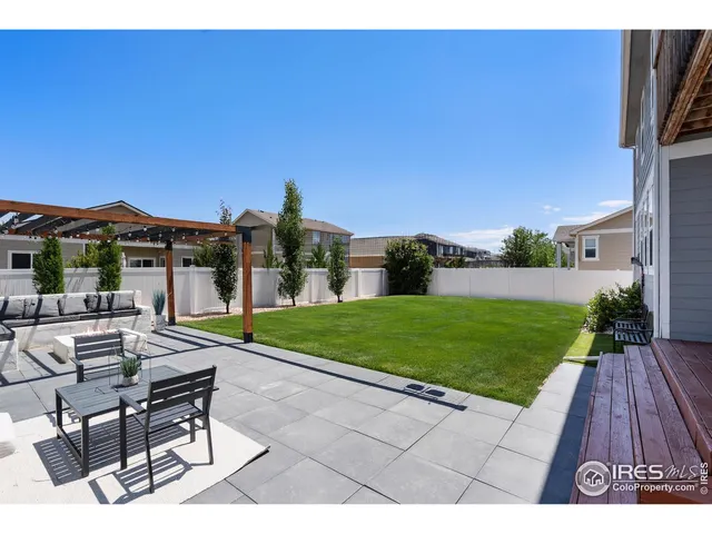 a view of a patio with a table and chairs