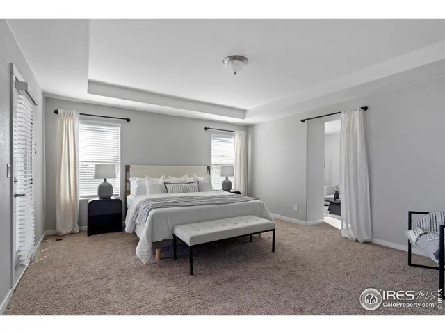 a spacious bedroom with a bed and a window