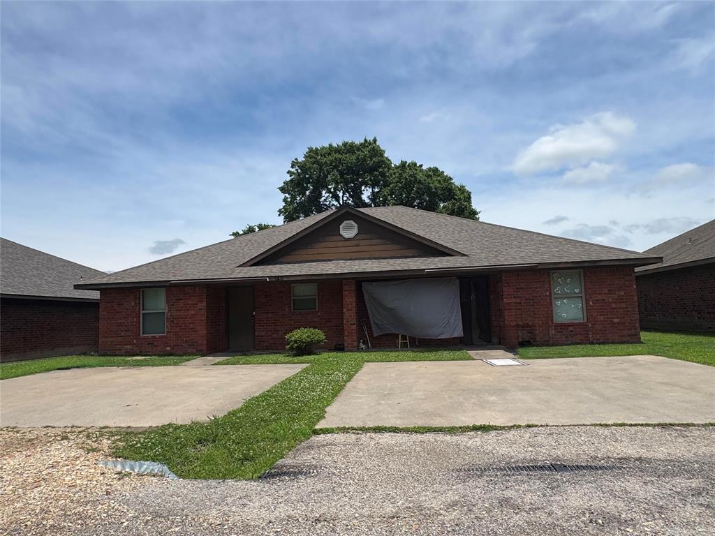 4515 Southeast Loop 286 Paris, TX 75460 - Photo 2 of 37 a front view of a house with a yard and garage