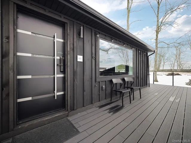 a large room with pool table and couches