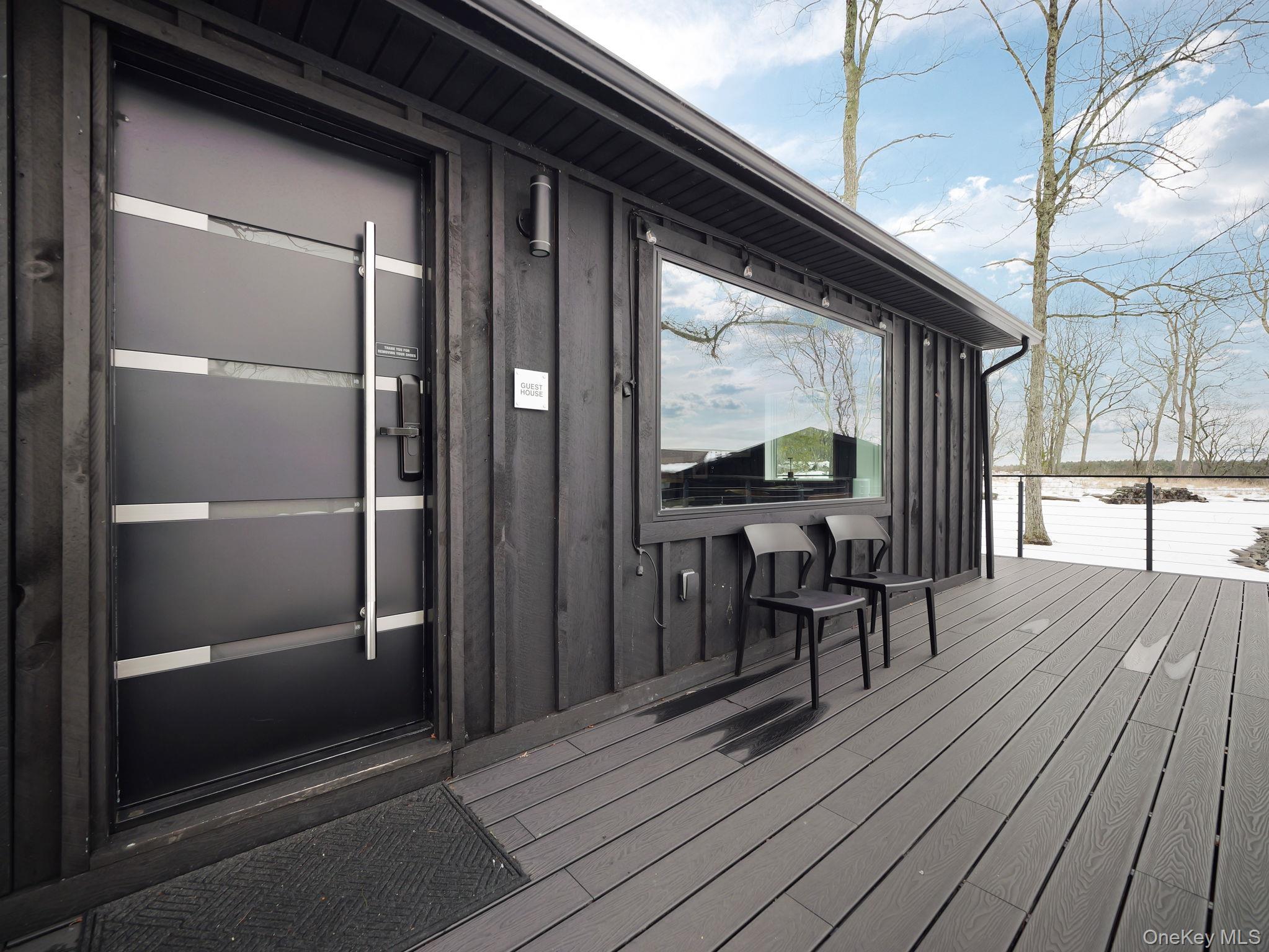 125 Mapes Road Barryville, NY 12719 - Photo 15 of 37 a view of a wooden deck with table and chairs