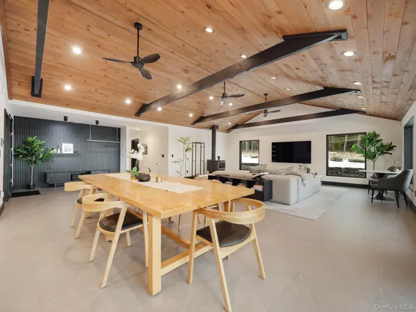 a kitchen with granite countertop a stove a sink a dining table and chairs