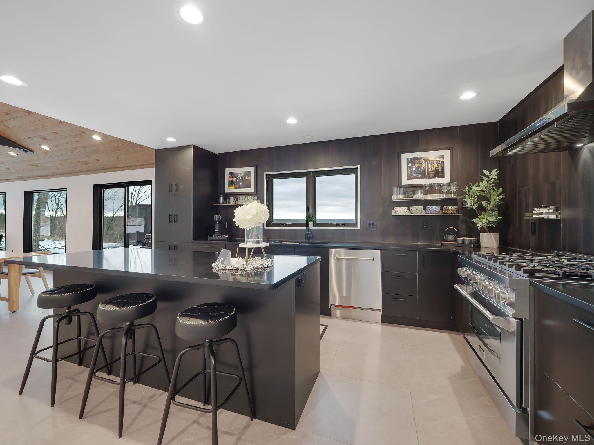 125 Mapes Road Barryville, NY 12719 - Photo 20 of 37 a kitchen with granite countertop a stove a sink a dining table and chairs