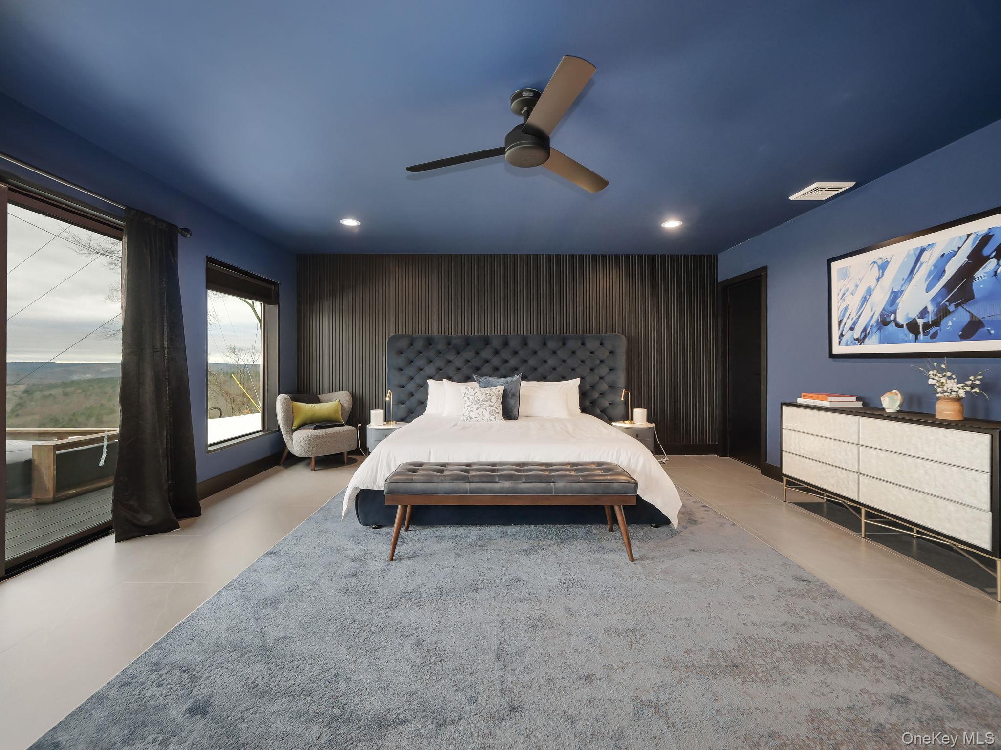 125 Mapes Road Barryville, NY 12719 - Photo 22 of 37 a spacious bedroom with a bed a couch and large window