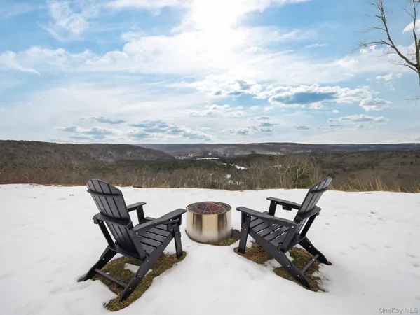 a view of a lake with outdoor seating space