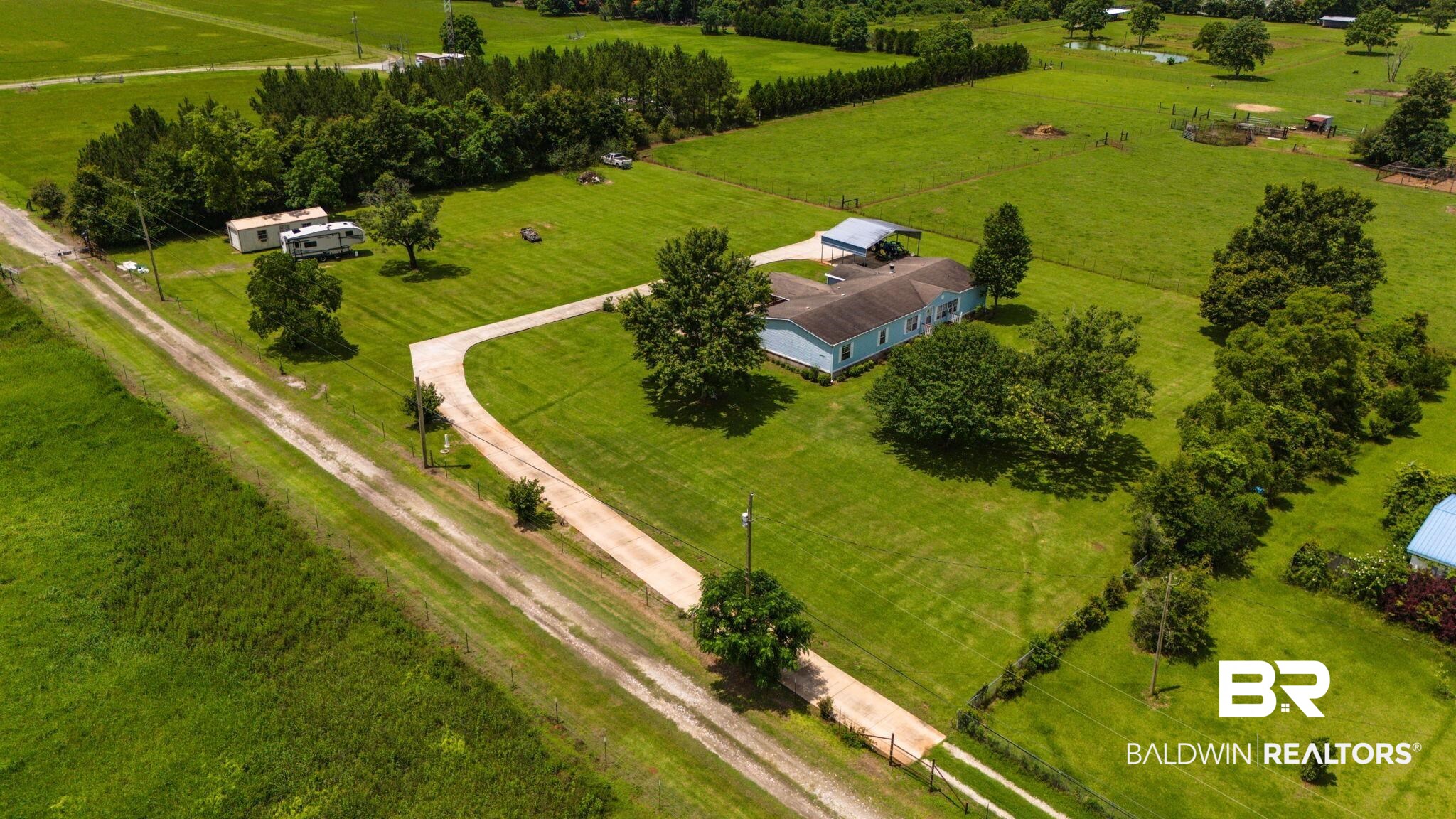 34985b Spring Road South, Unit B Stapleton, AL 36578 - Photo 28 of 31 Expansive green acreage featuring a single-story residence with a light blue exterior