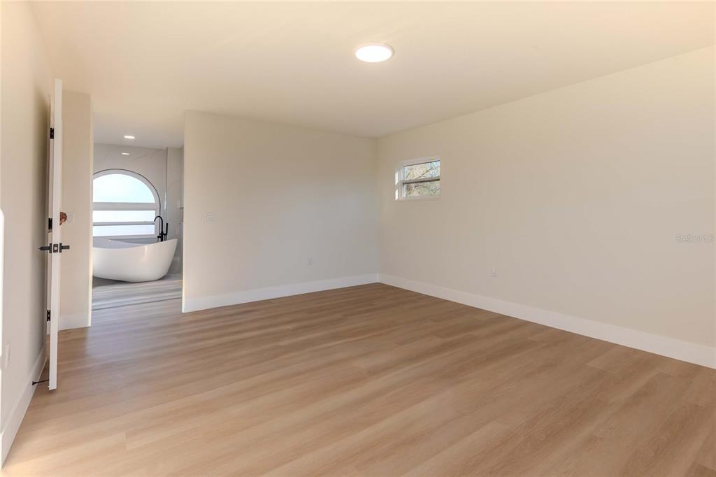 3324 Haystack Road Wesley Chapel, FL 33543 - Photo 11 of 91 a view of a room with wooden floor and window