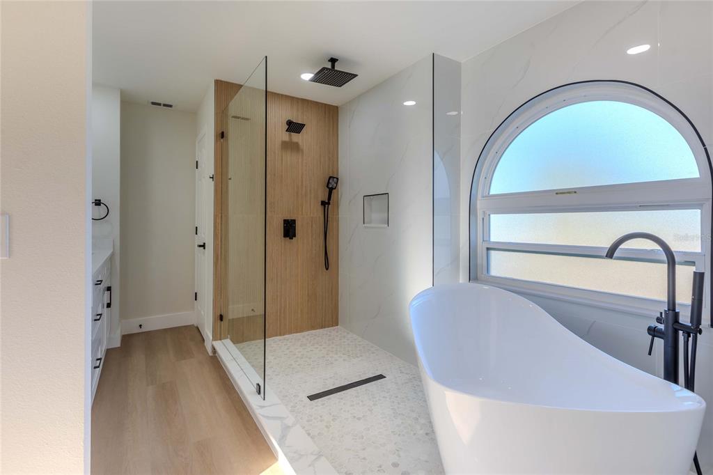 3324 Haystack Road Wesley Chapel, FL 33543 - Photo 16 of 91 a spacious bathroom with a glass door shower and a sink