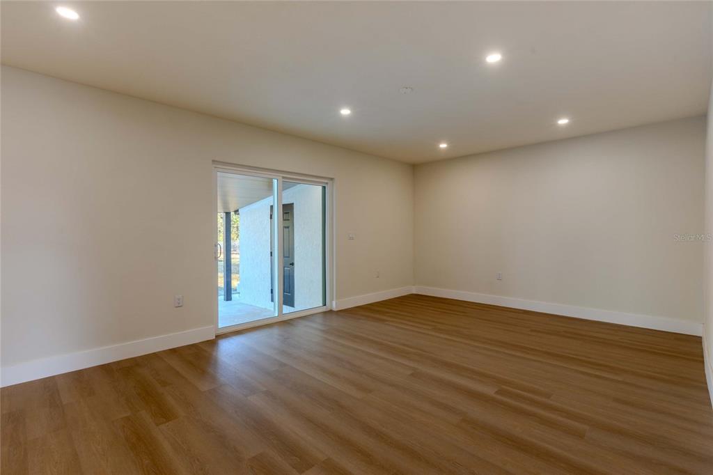 3324 Haystack Road Wesley Chapel, FL 33543 - Photo 19 of 91 a view of an empty room with wooden floor and a window