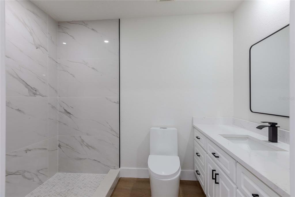 3324 Haystack Road Wesley Chapel, FL 33543 - Photo 24 of 91 a bathroom with a granite countertop sink toilet and shower