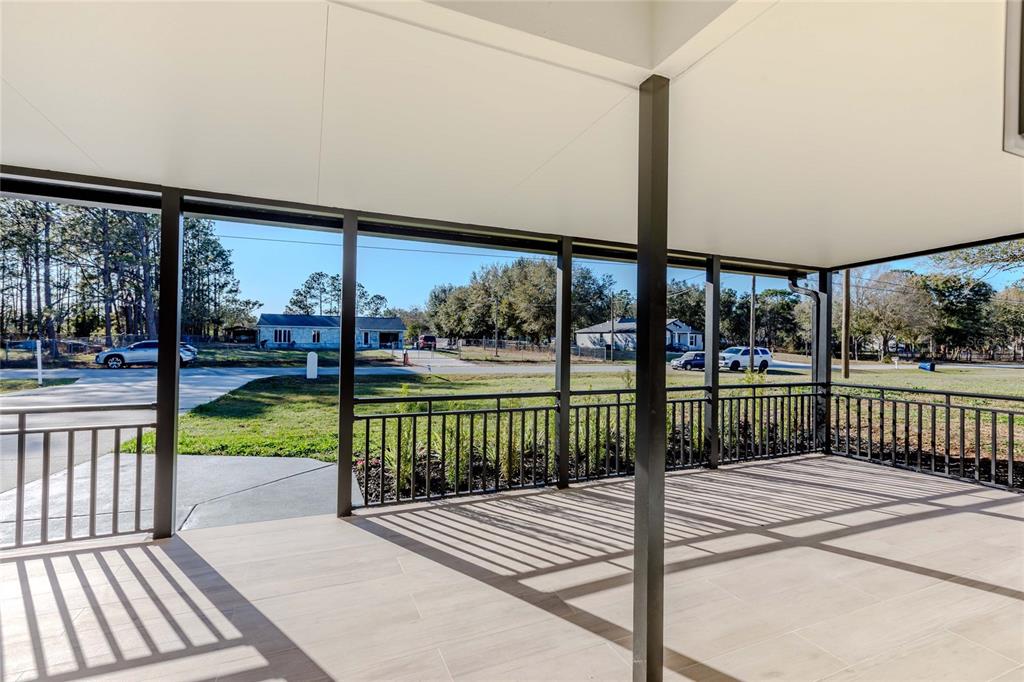 3324 Haystack Road Wesley Chapel, FL 33543 - Photo 27 of 91 a view of a porch with wooden floor and fence