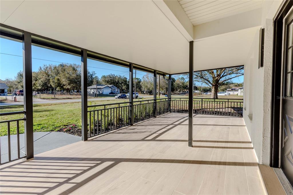 3324 Haystack Road Wesley Chapel, FL 33543 - Photo 35 of 91 a view of a balcony with a floor to ceiling window wooden floor and door