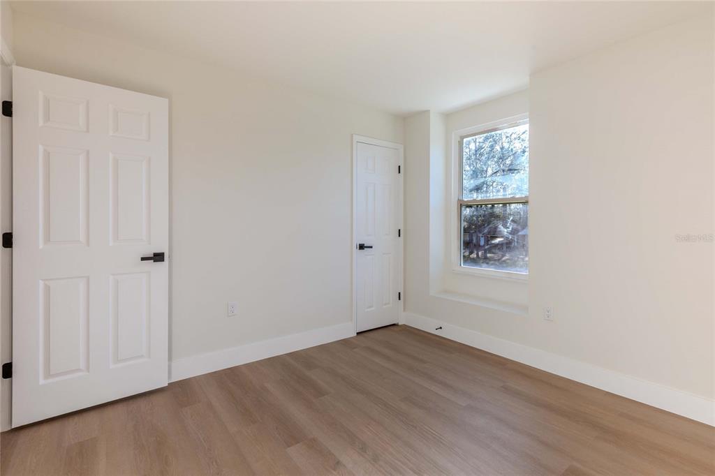 3324 Haystack Road Wesley Chapel, FL 33543 - Photo 47 of 91 an empty room with wooden floor and windows