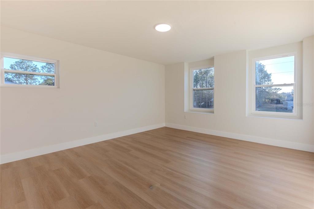 3324 Haystack Road Wesley Chapel, FL 33543 - Photo 57 of 91 a view of an empty room with window and wooden floor